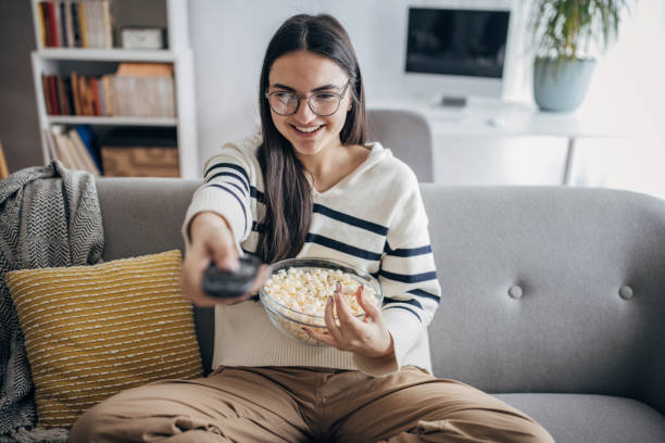 istock Woman changing channels on TV 1468588110