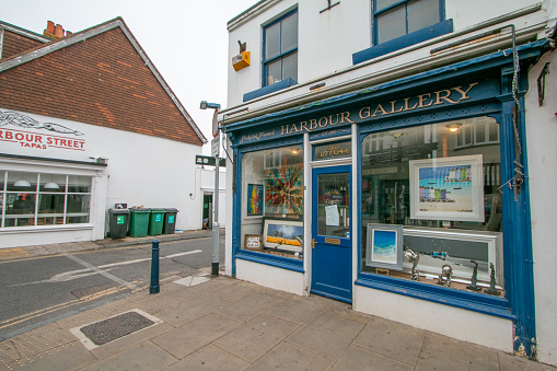 Harbour Art Gallery on Harbour Street at Whitstable in Kent, England, with paintings visible.