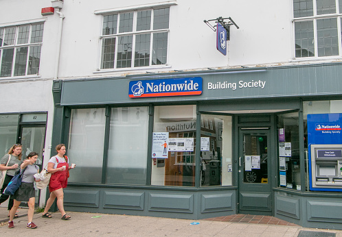 People walking past Nationwide Building Society on Whitstable High Street in Kent, England