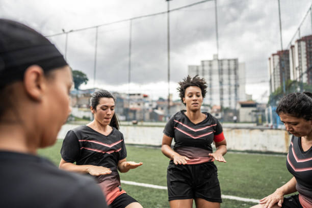 istock Female soccer team doing warm up exercise before match 1468592817