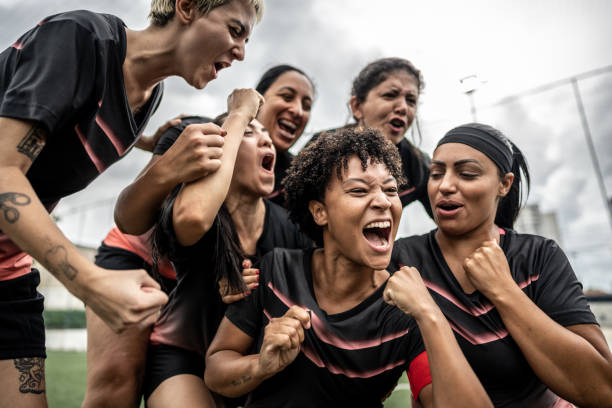 istock Happy female soccer team celebrating 1468592846