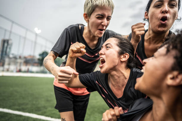 istock Happy female soccer team celebrating 1468593427