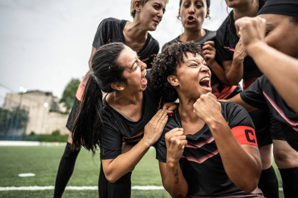 istock Happy female soccer team celebrating 1468593431