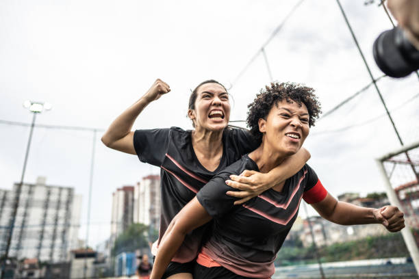 istock Happy female soccer players celebrating 1468593448