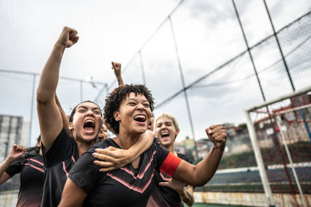 Happy female soccer team celebrating