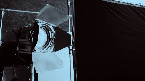 istock Film light for video production camera in studio set. Use as studio photo shoot light. Big LED spot light 5000w and diffuser or black panel create light like sun light can make daytime or golden hour 1468593480