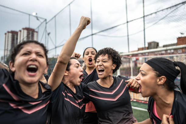 istock Happy female soccer team celebrating 1468593525