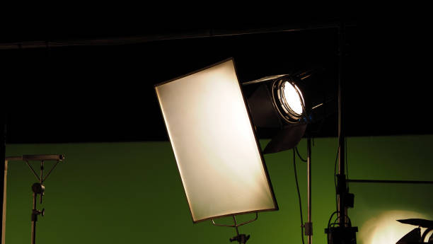istock Film light for video production camera in studio set. Use as studio photo shoot light. Big LED spot light 5000w and diffuser or black panel create light like sun light can make daytime or golden hour 1468593537