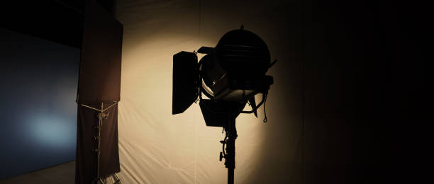 istock Film light for video production camera in studio set. Use as studio photo shoot light. Big LED spot light 5000w and diffuser or black panel create light like sun light can make daytime or golden hour 1468593702