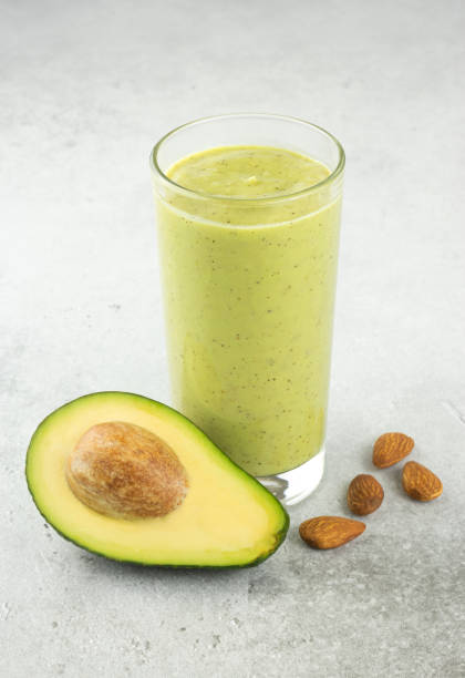 istock Avocado smoothie on a gray background. Green smoothie with avocado and almonds. Selective focus. 1468594073