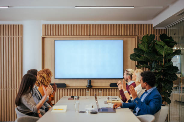 istock Group of businesspeople watching presentation on screen. 1468596174
