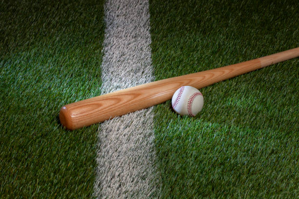 istock Baseball and bat on grass field with white stripe 1468596317