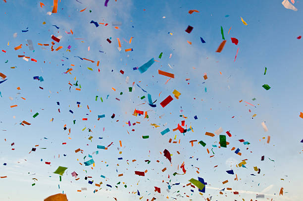 Square shaped paper confetti falling over blue background.