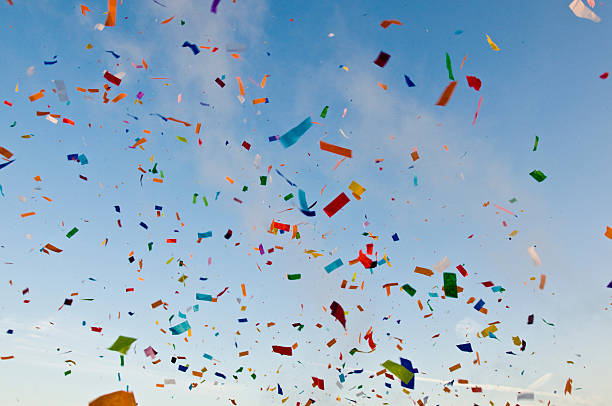 Confetti paper filled colorful blue sky background stock photo