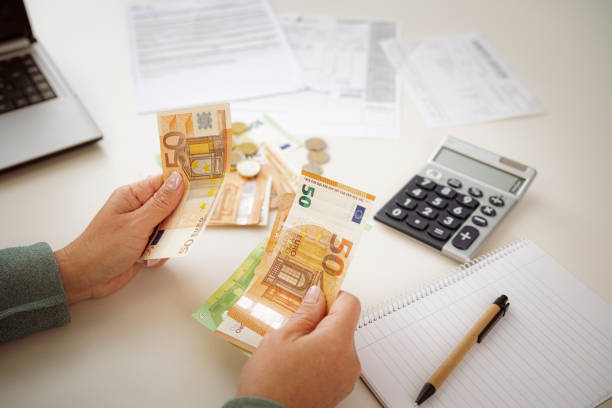 istock Woman's hands counting Euro banknotes planning home budget 1468597542