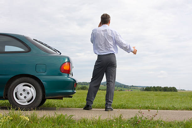 istock Businessman talking on cell phone beside his car 146859763