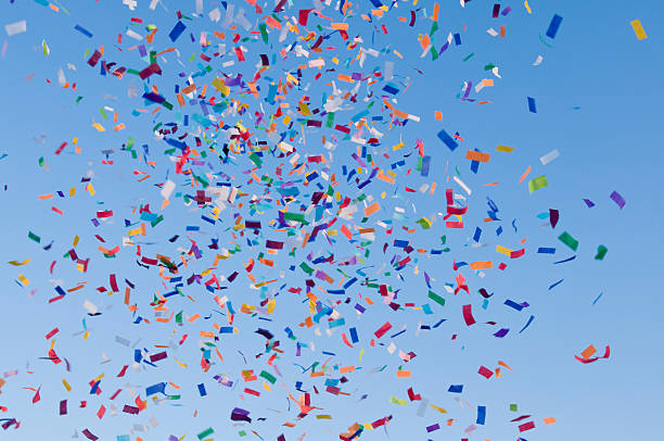 Confetti paper filled colorful blue sky background