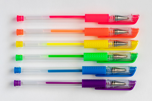 Colorful set of neon rainbow colors gel pens on white background