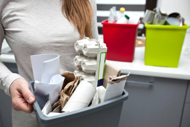 istock The woman is holding the full plastic box with assorted paper garbage 1468602435