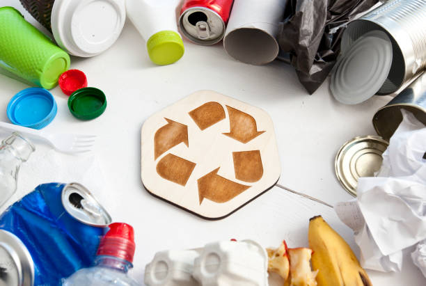 istock A lot of different garbage on the table and the recycling icon between them 1468602586