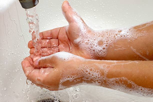 Washing Hands A child's hands washing under running water in a sink ian stock pictures, royalty-free photos & images