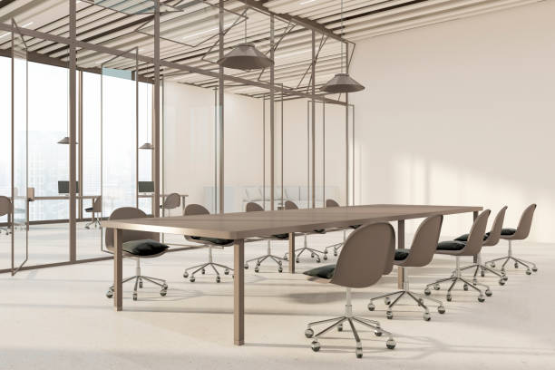istock Perspective view on huge empty conference table surrounded by brown chairs in light spacious meeting room with city view background behind transparent glass partitions. 3D rendering 1468606354