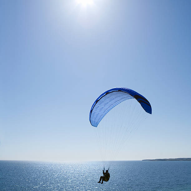 istock Person holding parachute against blue sky 146860817