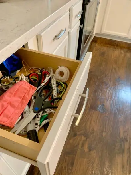 Photo of Unorganized Junk Drawer In Kitchen