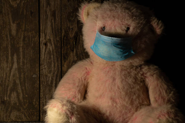istock bear in medical mask in a dark room 1468609134