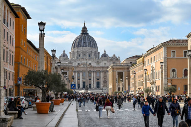 Rome, Lazio, Italy: Tourists in via della Conciliazione. Via della Conciliazione is the large road that connects Castel Sant'Angelo to Piazza San Pietro, where the same at the foot of the basilica is one of the largest in the world