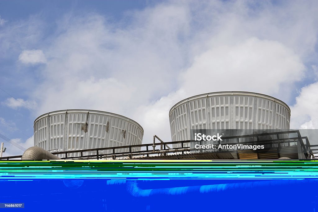 Cooling tower 3 Two cooling towers emitting steam, with a blue sky background Cooling Tower Stock Photo