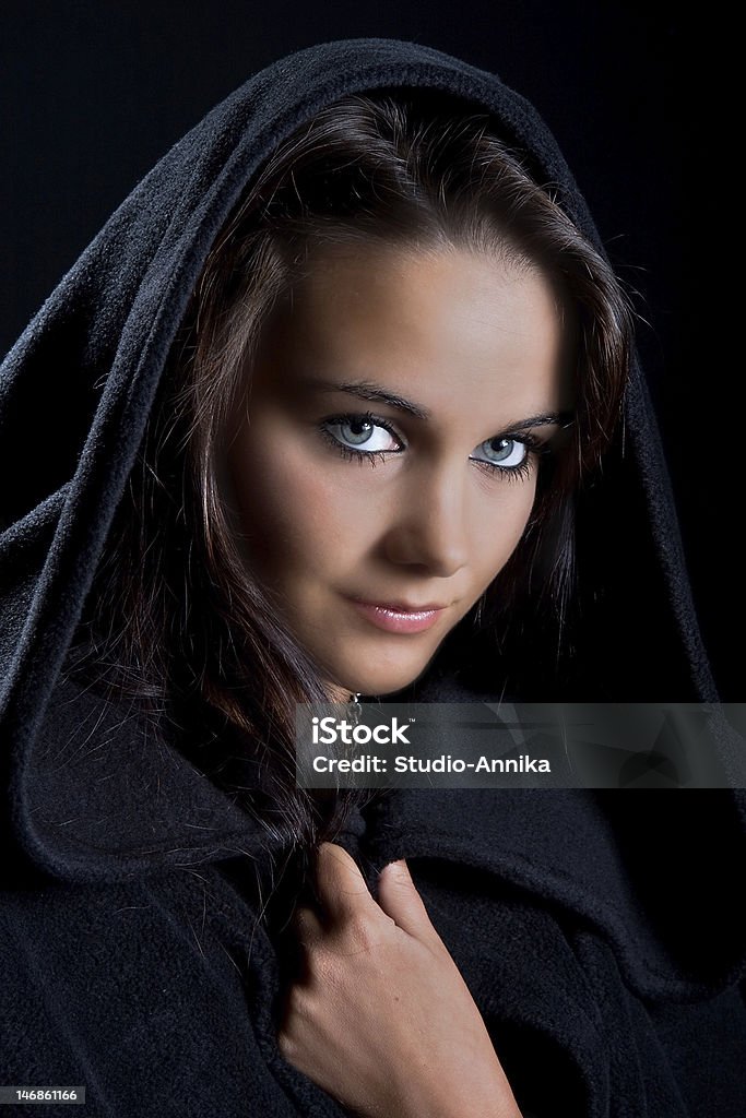 Lady in a black cape Dramatic portrait of a young lady in a black cape, may-be a young witch Adult Stock Photo
