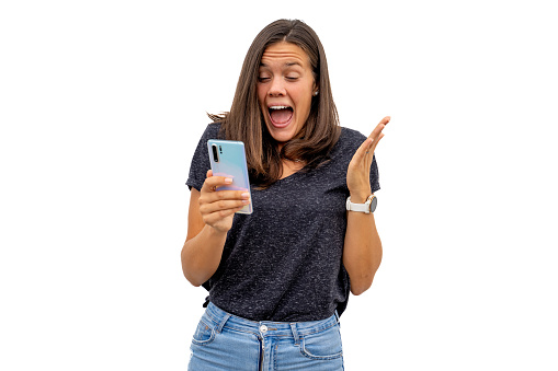 Exhilarated Young woman receiving good news on her phone