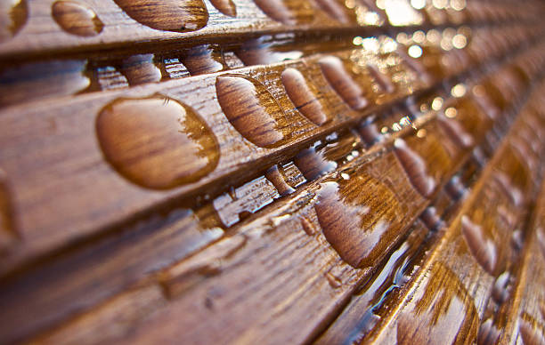 Raindrops on wooden plank stock photo