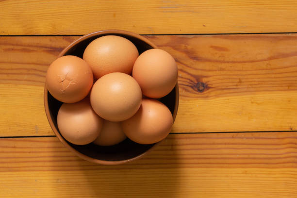 istock yellow chicken eggs on old wooden table table 1468617835