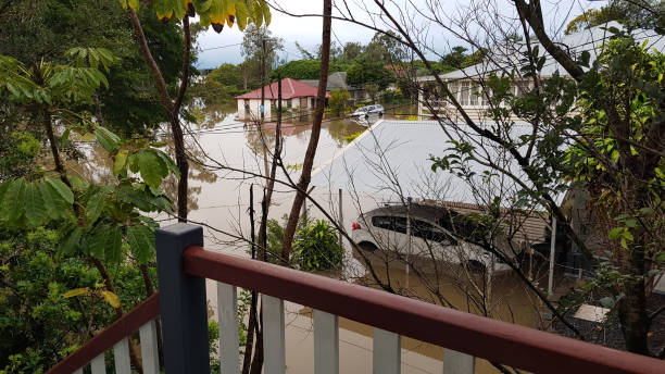 Brisbane, Australia - Feb 28, 2022: View from flooded home. Road, cars, and houses flooded after the heavy rain in Rocklea suburb Brisbane, Australia - Feb 28, 2022: View from flooded home. Road, cars, and houses flooded after the heavy rain in Rocklea suburb queensland floods stock pictures, royalty-free photos & images