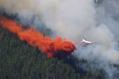 Fighting a forest fire in the mountains using anairplane