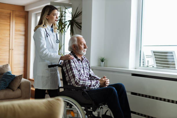 istock Mature  man and his caregiver looking through window at home 1468620475