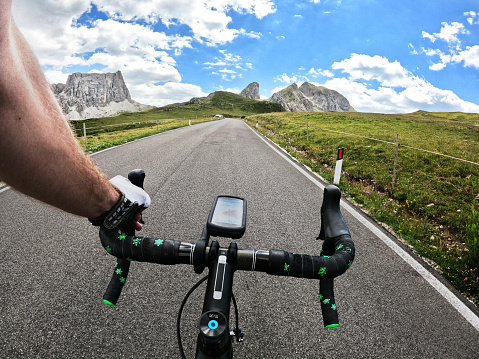 Personal perspective of a Young woman discovering Italian Dolomites on bicycle