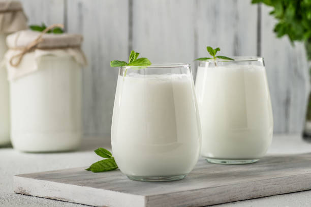 Glass cup of Turkish traditional drink ayran , kefir or buttermilk made from yogurt, healthy food stock photo