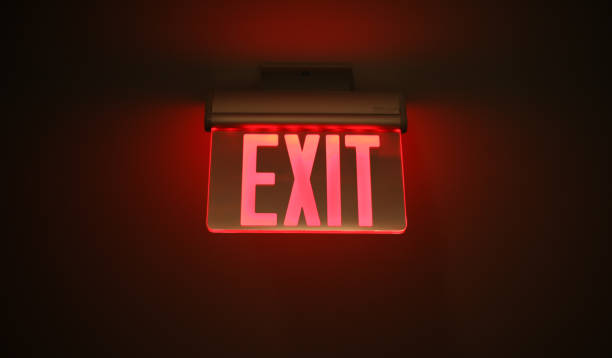 istock Hallway exit sign vibrant in corridor showing evacuation during emergency neon 1468633363