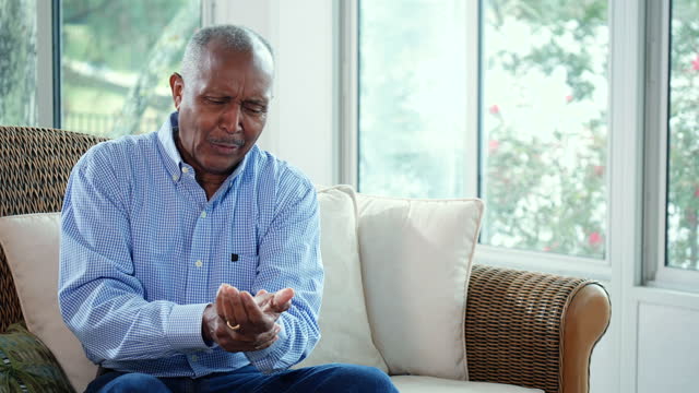 Senior African-American man with pain from elbow to wrist