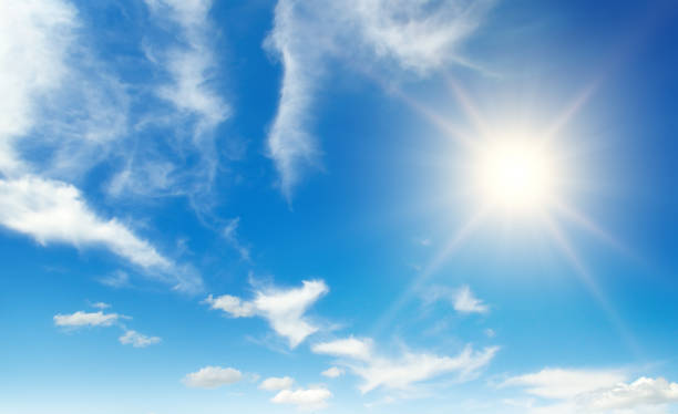 istock Bright sun on beautiful blue sky with white clouds. 1468637008