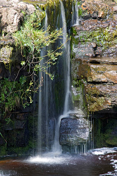 Slow motion small waterfall into river Yorkshire Dales stock photo