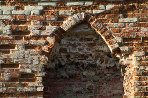istock Old damaged brick wall with an arch. 1468639578