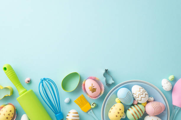 istock Easter cooking concept. Top view photo of plates with easter eggs kitchen utensils and baking molds on isolated pastel blue background with blank space 1468642177