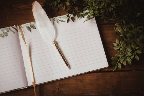 Guest book at a wedding with a pen and greenery
