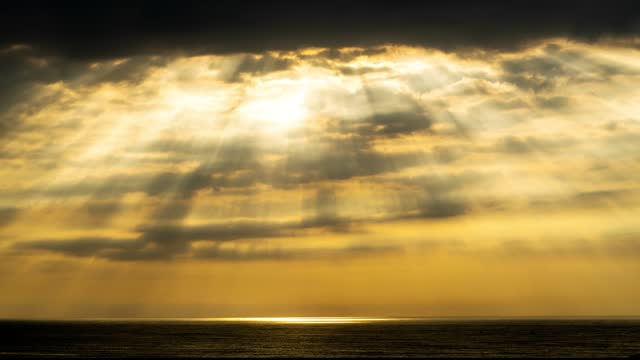 4k time lapse : light beam through the cloud over the sea