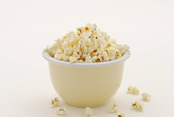 istock Buttered Popcorn in Yellow Bowl on White with Copy Space 146864675