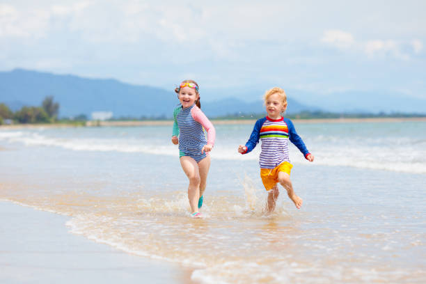 istock Kids on tropical beach. Children playing at sea. 1468653151